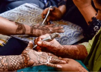 Women applying mehndi