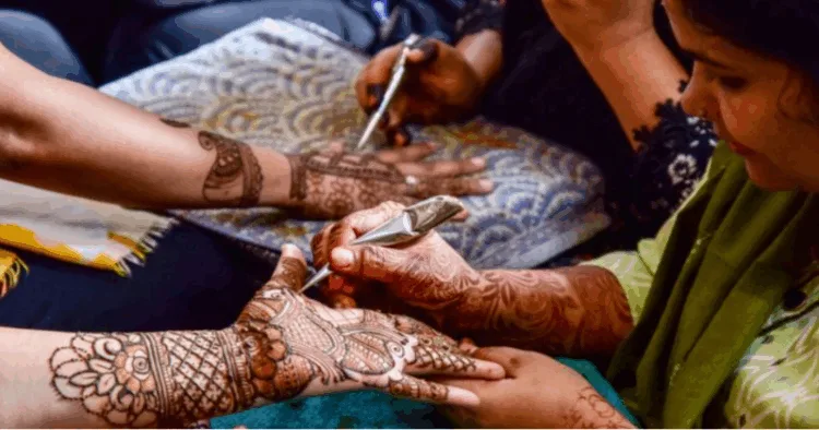 Women applying mehndi