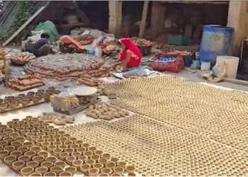 Women making diyas for Deepawali