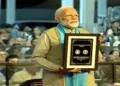 PM Narendra Modi with the commemorative coin in honour of Sardar Patel