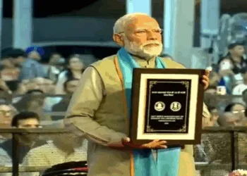 PM Narendra Modi with the commemorative coin in honour of Sardar Patel