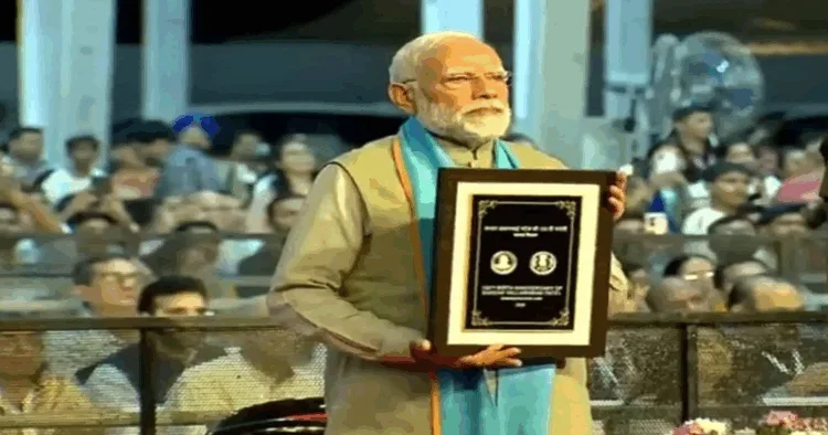 PM Narendra Modi with the commemorative coin in honour of Sardar Patel