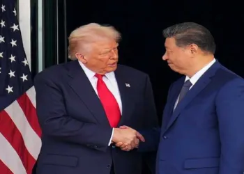 US President Donald Trump (left) and Chinese President Xi Jinping (right) shake hands as they depart from a bilateral meeting at Gimhae Air Base in Busan, South Korea, on Oct. 30