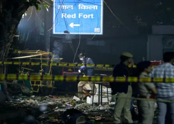 New Delhi, Nov 10 (ANI): A sign reading "Red Fort" as emergency personnel work at the site of the blast in a car near Gate no 1 of the Red Fort Metro station, in Delhi on November 10. (Reuters/ANI Photo)