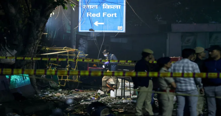 New Delhi, Nov 10 (ANI): A sign reading "Red Fort" as emergency personnel work at the site of the blast in a car near Gate no 1 of the Red Fort Metro station, in Delhi on November 10. (Reuters/ANI Photo)