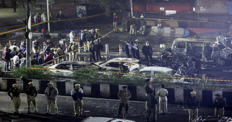 New Delhi, Nov 10 (ANI): Police officers and forensic technicians work at the site of the blast in a Hyundai i20 car near Gate No. 1 of the Red Fort Metro station, in Delhi on November 10. (Reuters/ANI Photo)