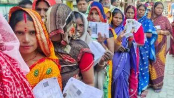 Women voters wait in a queue to cast their vote for the second phase of the Bihar assembly election, in West Champaran on Tuesday. (@CEOBiharX/ANI Photo)