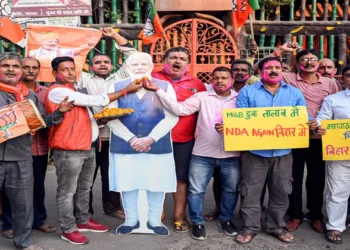 Patna, Nov 14 (ANI): BJP supporters with a cutout photograph of Prime Minister Narendra Modi as they celebrate NDA's lead in the vote counting of Bihar assembly election 2025 at the party office, in Patna on Friday. (ANI Photo)
