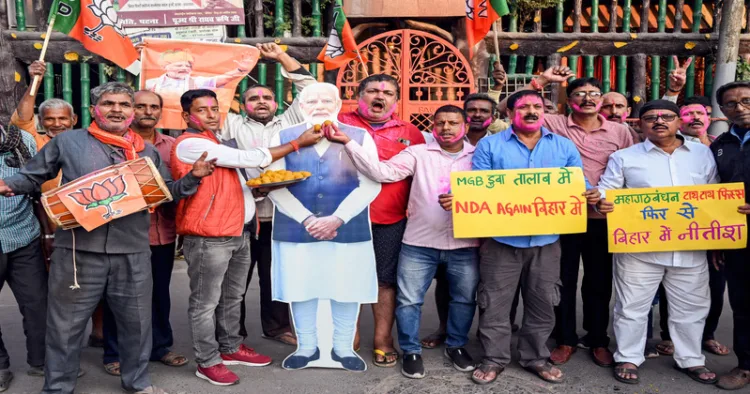 Patna, Nov 14 (ANI): BJP supporters with a cutout photograph of Prime Minister Narendra Modi as they celebrate NDA's lead in the vote counting of Bihar assembly election 2025 at the party office, in Patna on Friday. (ANI Photo)
