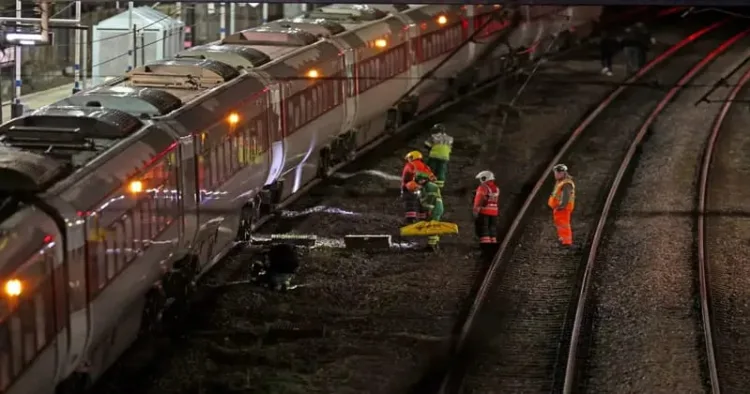 Emergency personnel inspect train at the Huntingdon, England