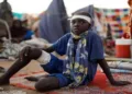 A boy sits at a camp for displaced people who fled from el-Fasher to Tawila, North Darfur