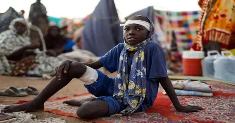 A boy sits at a camp for displaced people who fled from el-Fasher to Tawila, North Darfur