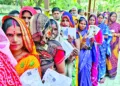 Women voters in a queue to cast their vote for the second phase of the Bihar assembly election, in West Champaran