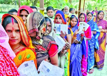 Women voters in a queue to cast their vote for the second phase of the Bihar assembly election, in West Champaran