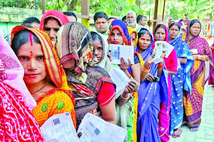 Women voters in a queue to cast their vote for the second phase of the Bihar assembly election, in West Champaran