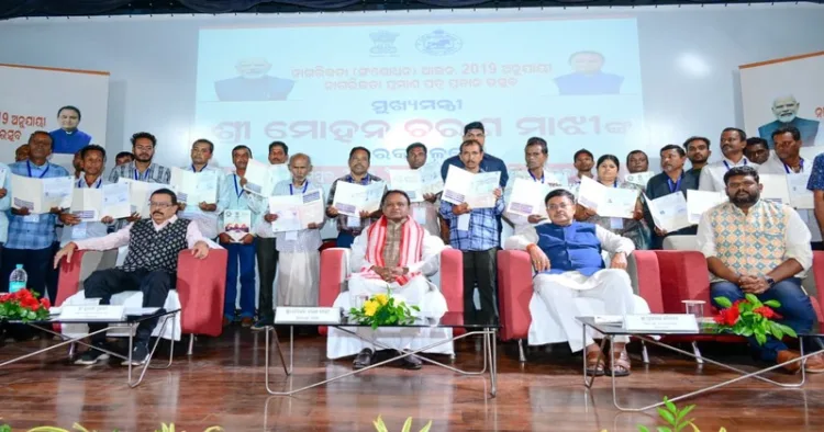 CM Mohan Majhi with receipents of citizenship certificates under the CAA 2019 during a programme held in Bhubaneswar