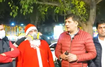 The clip features two men dressed as Santa Claus, with anti-pollution masks on, collapsing on the streets of Connaught Place