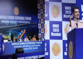 (Left) Dignitaries on the stage at the World Hindu Economic Forum (Right) Maharashtra CM Devendra Fadnavis addressing the gathering at WEHF