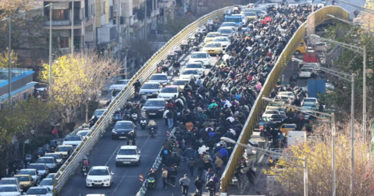 Protesters march through downtown Tehran on Monday against the theocratic rule of Ayatollah Ali Khamenei