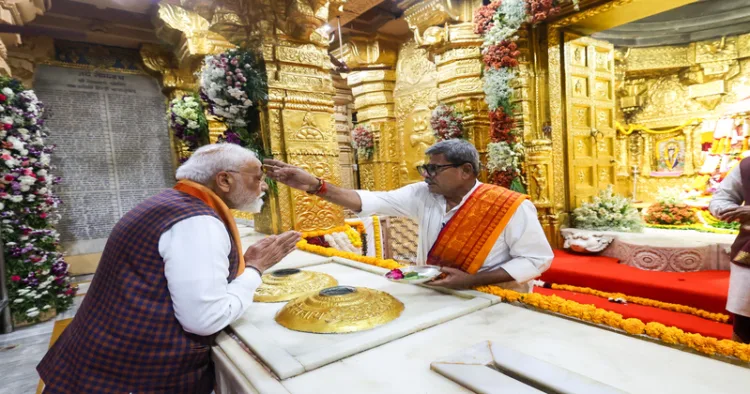 Gir Somnath, Jan 10 (ANI): A priest applies Chandan on the forehead of Prime Minister Narendra Modi at Somnath Temple, in Gir Somnath on Saturday. (DPR PMO/ANI Photo)