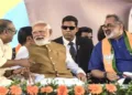 PM Modi interacts with BDJS leader and SNDP Yogam vice president Thushar Vellappalli during a public rally, in Thiruvananthapuram, Kerala. BJP state president Rajeev Chandrasekhar is also seen