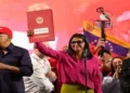 Venezuela's interim President Delcy Rodriguez holds up the newly signed oil reform bill, signalling a shift toward privatisation of the national oil sector amid US pressure