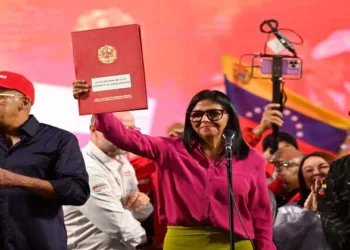 Venezuela's interim President Delcy Rodriguez holds up the newly signed oil reform bill, signalling a shift toward privatisation of the national oil sector amid US pressure