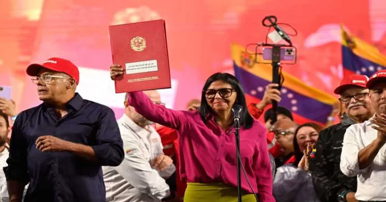 Venezuela's interim President Delcy Rodriguez holds up the newly signed oil reform bill, signalling a shift toward privatisation of the national oil sector amid US pressure