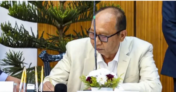 BJP legislator Yumnam Khemchand Singh signs during his swearing-in as new Manipur Chief Minister, in Imphal