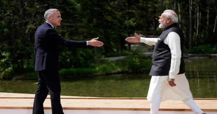 Prime Minister Narendra Modi and Canada's Prime Minister Mark Carney reach to shake hands at the G7 Summit in Kananaskis, Alberta