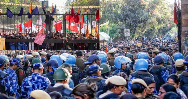 Heavy police deployment formed a barricade at the JNU entrance on Thursday as a large crowd of left activists gathered, reflecting the escalating tension on campus