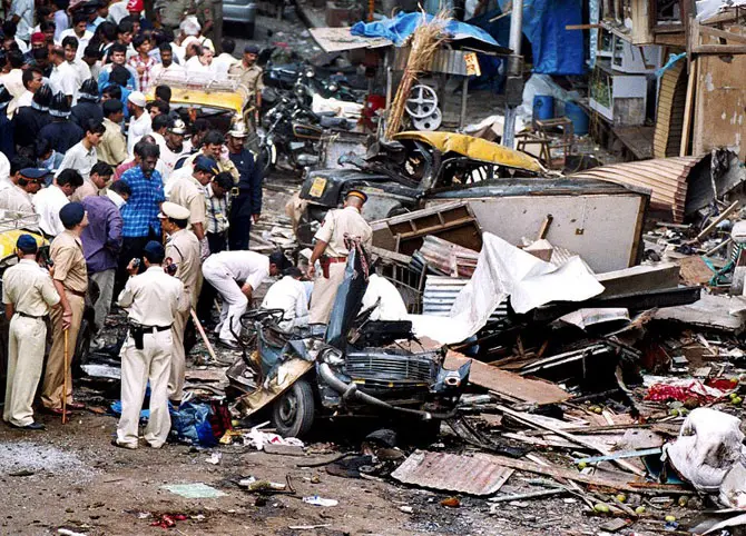 Police at the scene of one of the blasts. Pic/AFP