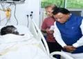 Odisha Chief Minister Mohan Charan Majhi speaks to victim of the fire at SCB Medical College and Hospital