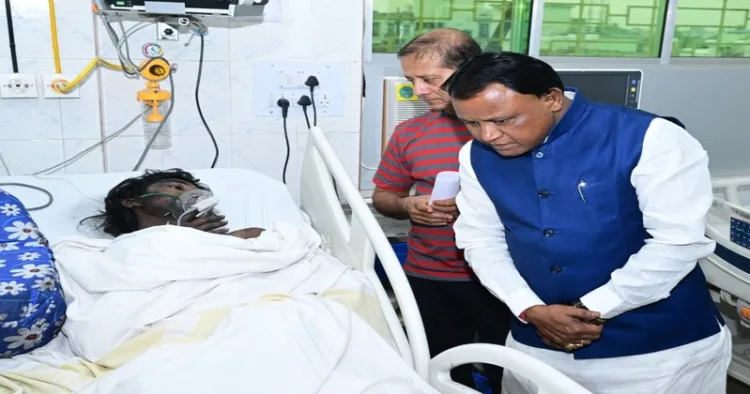 Odisha Chief Minister Mohan Charan Majhi speaks to victim of the fire at SCB Medical College and Hospital