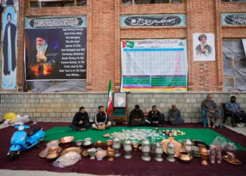 Volunteers wait at a collection point during a donation drive for Iran in Budgam, Indian-controlled Kashmir, Monday, March 23, 2026