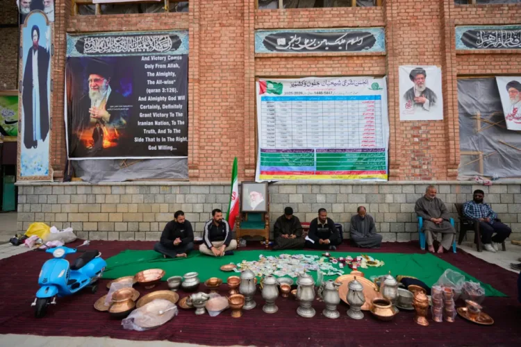 Volunteers wait at a collection point during a donation drive for Iran in Budgam, Indian-controlled Kashmir, Monday, March 23, 2026