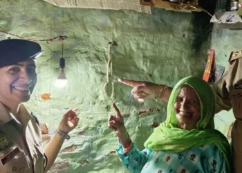 A representative image of an IPS officer bringing light to the house of an elderly woman