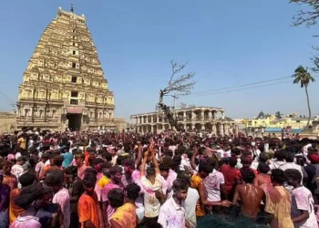 Hundreds of foreign tourists, gathered near the Virupaksha Temple to celebrate Holi