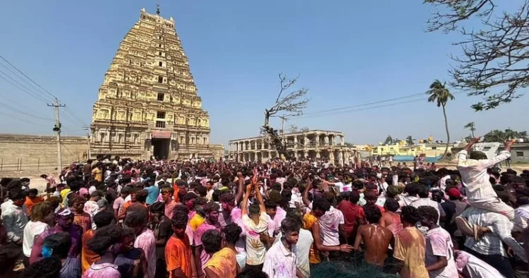 Hundreds of foreign tourists, gathered near the Virupaksha Temple to celebrate Holi