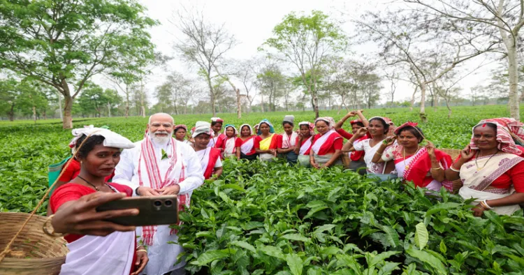 Dibrugarh [Assam], Apr 01 (ANI): Prime Minister Narendra Modi and women workers pose for a group selfie during his visit to a tea estate in Dibrugarh on Wednesday. (@narendramodi/ANI Photo)