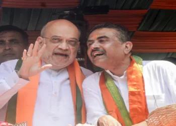 Kolkata, Apr 02 (ANI): Union Home Minister Amit Shah and West Bengal Assembly LoP and BJP candidate Suvendu Adhikari during the mega nomination rally for the Bhabanipur Assembly constituency, in Kolkata on Thursday. (ANI Photo)