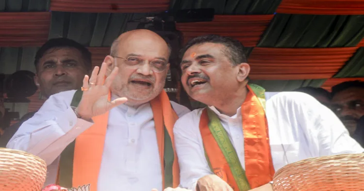 Kolkata, Apr 02 (ANI): Union Home Minister Amit Shah and West Bengal Assembly LoP and BJP candidate Suvendu Adhikari during the mega nomination rally for the Bhabanipur Assembly constituency, in Kolkata on Thursday. (ANI Photo)