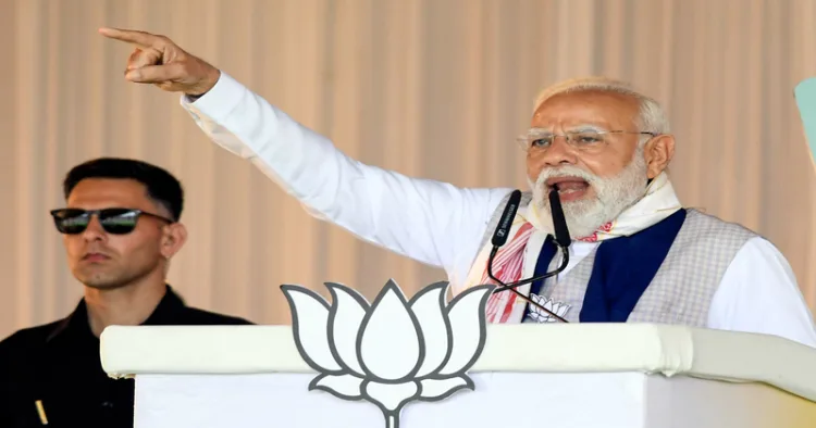Barpeta, Apr 06 (ANI): Prime Minister Narendra Modi speaks during a public event, in Barpeta on Monday. (ANI Photo)