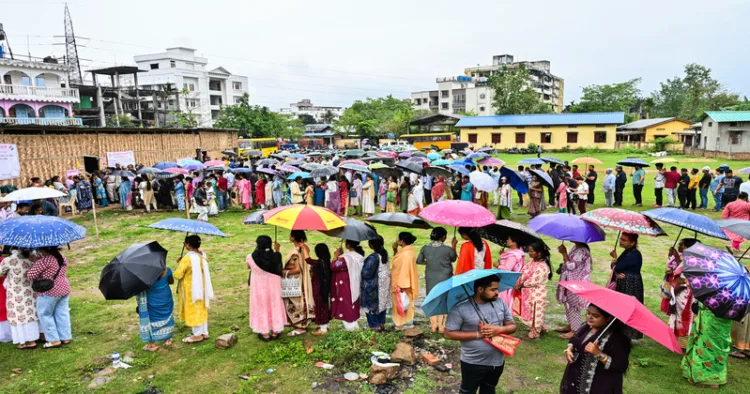 Guwahati [Assam], Apr 09 (ANI): Voters queue up as they wait to cast their votes amid rain at the polling station during the Assam Assembly Elections 2026 in Guwahati on Thursday. (ANI Photo)