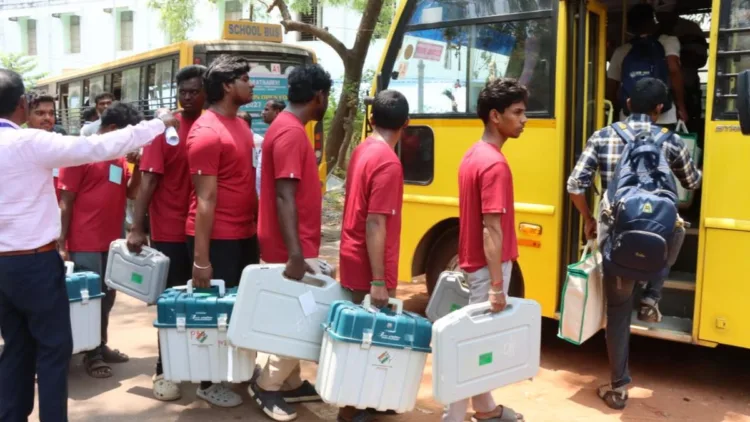 Polling officials at Mothilal Nehru Polytechnic College in Puducherry carry ballot boxes to be sent to various polling booths across the Union Territory