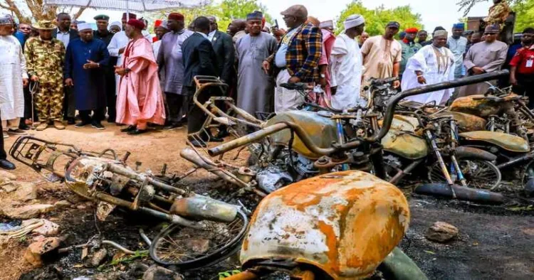 Residents stand near burned buildings after an attack by Islamic State-linked terrorists in Guyaku, Adamawa state, northeastern Nigeria, where at least 29 people were killed