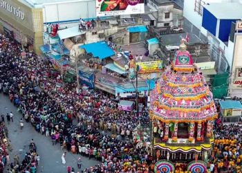 A massive crowd of devotees gathers to witness the grand temple car procession (Therottam) on the 11th day of the Chithirai Festival, in Madurai on Wednesday. (ANI Video Grab)