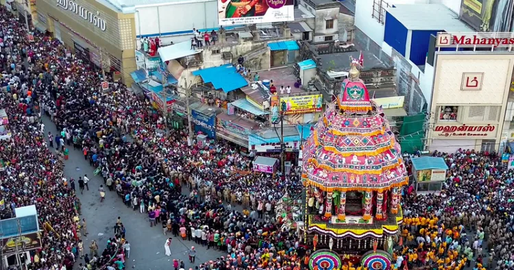 A massive crowd of devotees gathers to witness the grand temple car procession (Therottam) on the 11th day of the Chithirai Festival, in Madurai on Wednesday. (ANI Video Grab)