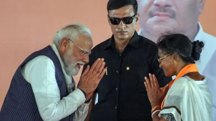 Prime Minister Narendra Modi and BJP candidate from Panihati Assembly constituency Ratna Debnath greet each other during the campaign for her ahead of the second phase of the West Bengal assembly elections