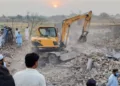 Locals gather at the site of the blast in Bannu district of Khyber Pakhtunkhwa